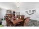 Formal dining room featuring hardwood table with seating for eight and a stylish light fixture at 21093 E 53Rd Ave, Denver, CO 80249