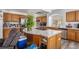 Bright kitchen featuring stainless steel appliances, a curved island, and plenty of cabinet space at 21093 E 53Rd Ave, Denver, CO 80249