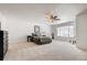 Spacious main bedroom with a ceiling fan, neutral walls, a large window and plush carpet at 21093 E 53Rd Ave, Denver, CO 80249