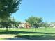 Neighborhood playground with a variety of play structures, surrounded by green grass and trees at 21093 E 53Rd Ave, Denver, CO 80249