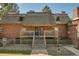 Front view of a brick building with wood shake roof and balcony at 5401 E Warren Ave # 204, Denver, CO 80222