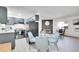 Open concept kitchen and dining area with modern appliances and fireplace at 5401 E Warren Ave # 204, Denver, CO 80222