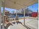 Covered patio with seating area, overlooking a fenced-in yard with a shed and small pool at 2525 Nelson St, Lakewood, CO 80215