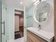 Basement bathroom with walk-in shower, modern vanity, and hexagonal floor tile at 2525 Nelson St, Lakewood, CO 80215