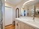 Bathroom with a white vanity, large mirror and glass block shower at 2525 Nelson St, Lakewood, CO 80215