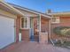 Brick front entry with red door, stone accents, and welcome mat at 2525 Nelson St, Lakewood, CO 80215