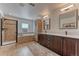 Bright bathroom with separate shower and tub, double sinks, and a large mirror at 9274 Viaggio Way, Highlands Ranch, CO 80126