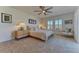 Bright bedroom featuring soft carpet, a large window with shutters, and a ceiling fan at 9274 Viaggio Way, Highlands Ranch, CO 80126