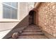 Charming front entrance with brick steps and decorative stone accents at 9274 Viaggio Way, Highlands Ranch, CO 80126