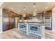 Modern kitchen featuring dark wood cabinets, stainless steel appliances, and a granite island with bar seating at 9274 Viaggio Way, Highlands Ranch, CO 80126