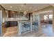 Modern kitchen with dark cabinetry, island, and dining area at 9274 Viaggio Way, Highlands Ranch, CO 80126