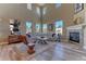 Bright living room with high ceilings, fireplace and ample windows at 9274 Viaggio Way, Highlands Ranch, CO 80126