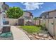 Fully fenced backyard with a shed, playhouse, swing, bench, and lush green grass, perfect for outdoor activities at 5153 Andes Way, Denver, CO 80249