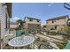 Cozy balcony with a white table and chairs, perfect for enjoying outdoor views in a residential setting at 5153 Andes Way, Denver, CO 80249