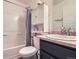 Bathroom featuring a shower with a curtain, a vanity, and a toilet at 5153 Andes Way, Denver, CO 80249