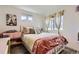 Well decorated bedroom with lots of pillows, comforter, and a nice bed frame at 5153 Andes Way, Denver, CO 80249