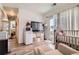 Bedroom area featuring a crib, tv, and walkout patio access at 5153 Andes Way, Denver, CO 80249