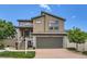 Two-story home featuring neutral siding, a two car garage, and a well-manicured front yard at 5153 Andes Way, Denver, CO 80249