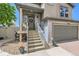 Inviting front porch with stairs leading to the entrance and a well-manicured lawn at 5153 Andes Way, Denver, CO 80249