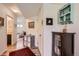 Inviting hallway with wood-look flooring, decor, and storage cabinets, leading to other areas of the home at 5153 Andes Way, Denver, CO 80249