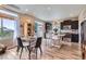 Dining room adjacent to a modern kitchen featuring dark cabinets and stainless steel appliances at 5153 Andes Way, Denver, CO 80249