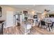 Open floor plan featuring a kitchen with stainless steel appliances, an island, and hardwood floors at 5153 Andes Way, Denver, CO 80249