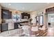 Kitchen with granite countertops, stainless steel appliances, an island, and dark cabinetry at 5153 Andes Way, Denver, CO 80249