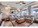 Comfortable living room with tray ceilings, large windows and neutral colored decor at 5153 Andes Way, Denver, CO 80249