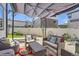 Backyard patio setup with comfortable seating, a decorative rug, and a sunshade for outdoor relaxation at 5153 Andes Way, Denver, CO 80249