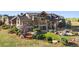 Expansive backyard with lush landscaping, a charming bridge, and an impressive stone-clad home at 19155 Lochmere Ct, Monument, CO 80132