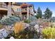 Stunning backyard featuring a koi pond and bridge, surrounded by lush landscaping and mature trees at 19155 Lochmere Ct, Monument, CO 80132