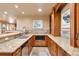 Granite countertop bar area boasts a stainless steel sink and built-in microwave at 19155 Lochmere Ct, Monument, CO 80132