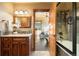 Stylish bathroom with a wood vanity and a view into the exercise room at 19155 Lochmere Ct, Monument, CO 80132
