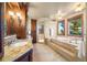 Luxurious bathroom with a soaking tub, walk-in shower and granite countertops at 19155 Lochmere Ct, Monument, CO 80132