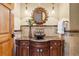 Elegant powder room featuring a marble countertop, vessel sink, and decorative mirror at 19155 Lochmere Ct, Monument, CO 80132