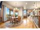 Bright dining room featuring hardwood floors, a chandelier and large windows with scenic views at 19155 Lochmere Ct, Monument, CO 80132