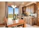 Dining room features wood cabinetry, a large window with views, and a rustic table at 19155 Lochmere Ct, Monument, CO 80132