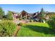 Beautiful home with mature trees, well-maintained lawn, circular driveway, and porte cochere at 19155 Lochmere Ct, Monument, CO 80132