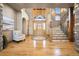 Welcoming foyer featuring hardwood floors, a curved staircase, and a bright, open entryway at 19155 Lochmere Ct, Monument, CO 80132