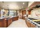 Spacious kitchen with custom cabinets, large island, granite counters and stainless steel appliances at 19155 Lochmere Ct, Monument, CO 80132