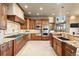 Spacious kitchen features custom wood cabinetry, stainless steel appliances, and granite countertops at 19155 Lochmere Ct, Monument, CO 80132