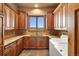 Functional laundry room boasts ample storage, granite counters, and scenic views at 19155 Lochmere Ct, Monument, CO 80132