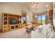 Comfortable living room with a cozy sofa, entertainment center, and views of the outdoors at 19155 Lochmere Ct, Monument, CO 80132