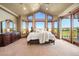 Bright main bedroom featuring scenic views from floor to ceiling windows and a private balcony at 19155 Lochmere Ct, Monument, CO 80132