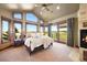 Serene main bedroom with large windows, a cozy fireplace, and a private balcony that has panoramic views at 19155 Lochmere Ct, Monument, CO 80132