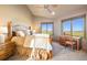 Serene primary bedroom with large windows offering picturesque views and soft natural light at 19155 Lochmere Ct, Monument, CO 80132