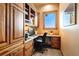 Cozy home office with custom wooden built-ins, granite countertops, and bright natural light at 19155 Lochmere Ct, Monument, CO 80132