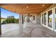 Expansive stone patio with wood ceiling and recessed lighting, ideal for outdoor living and entertainment at 19155 Lochmere Ct, Monument, CO 80132