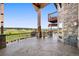 Spacious outdoor patio with stone pillars and golf course view, perfect for relaxing and entertaining at 19155 Lochmere Ct, Monument, CO 80132