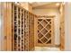 Custom-built wine cellar with wooden racking and door for secure storage, perfect for wine enthusiasts at 19155 Lochmere Ct, Monument, CO 80132